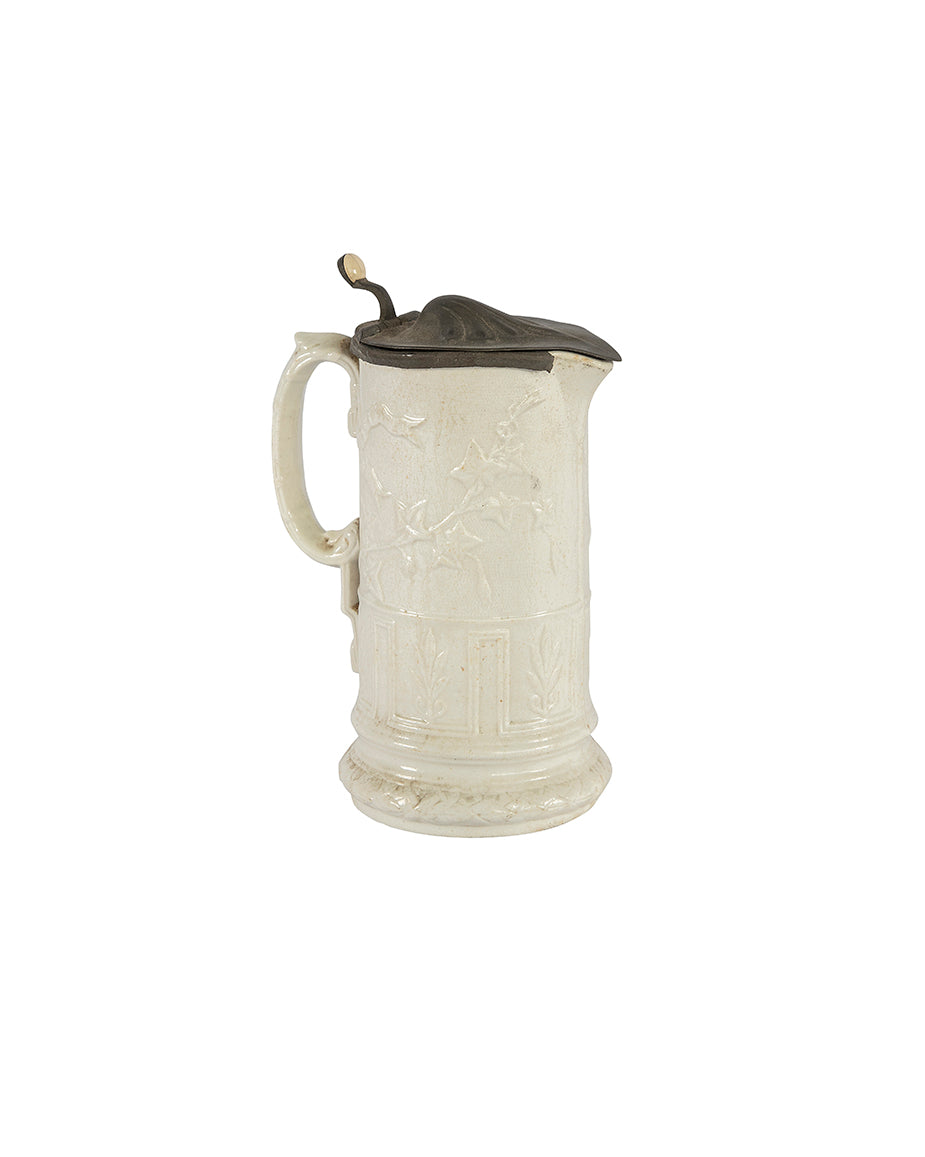 Carved porcelain jug with a pewter lid