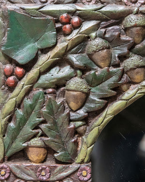 Espejo de madera tallada y policromada con representaciones vegetales