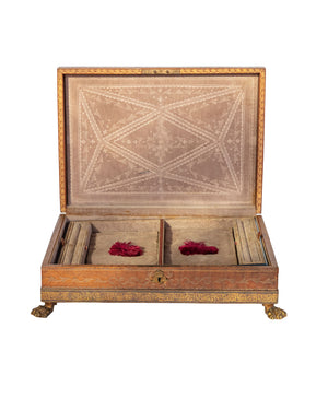 Engraved leather-lined jewelry box with brass feet and velvet interior
