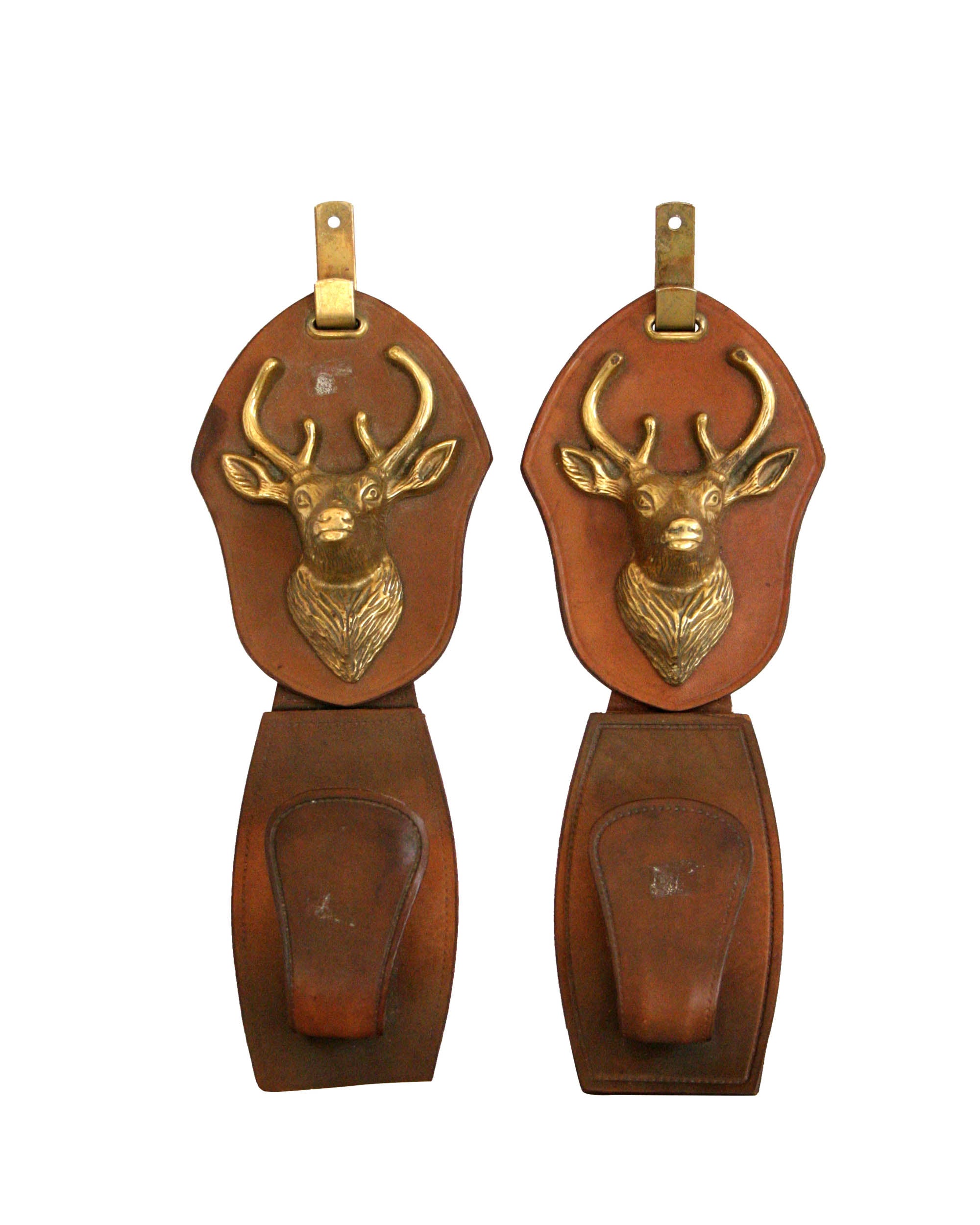 Couple of pegs made on leather with deer head carving in bronze