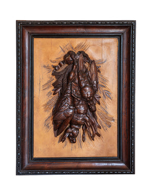 Pair of framed wood carvings with a hunting motif