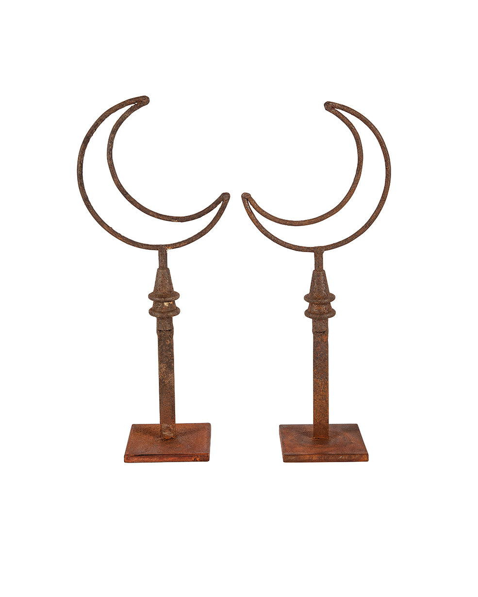 Pair of moon-shaped iron sculptures