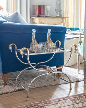 Side table “Lygne” with iron frame, bronze carved swans and braided metal tray