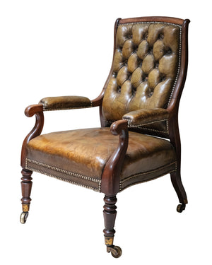 Mahogany armchair upholstered in olive green tufted leather on original bronze wheels. XIXth century 
