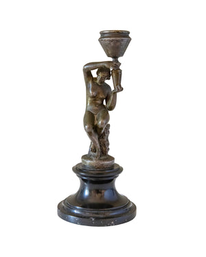 Pair of bronze candle-holders supported by naked women on a wooden pedestal